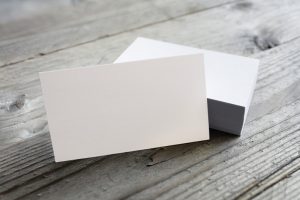 White business cards in a pile with one facing forward