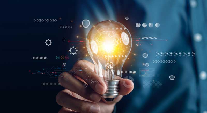 Glowing light bulb held in hand symbolizing innovation, ideas, and thought leadership in business