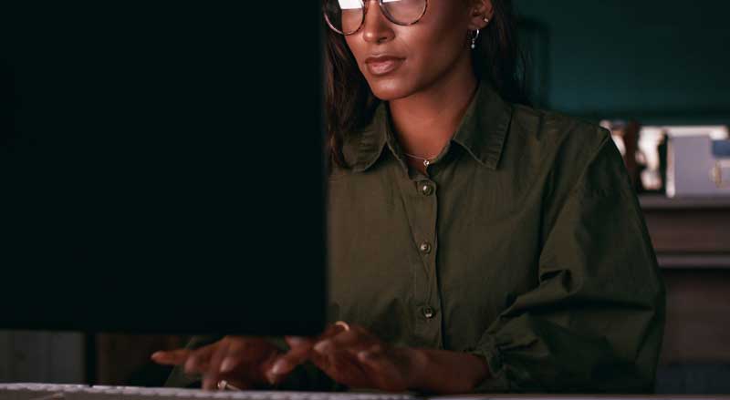 Business owner writing website content at a computer with focus on strategy and user intent